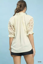 Cream-colored umgee linen v-neck top featuring delicate lace puff sleeve and ruffled cuffs for a feminine look