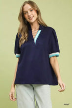 Navy blue Umgee Luxe knit contrast trim puff sleeve top with light teal and white striped collar and cuffs