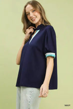 Navy blue umgee luxe knit contrast trim puff sleeve top with ruffled collar and teal accented short sleeves