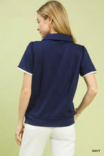 Navy blue umgee luxe knit short sleeve polo shirt with white trim on collar and sleeve cuffs for stylish comfort