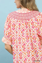 Coral and orange umgee mix boho puff sleeve top with smocked neckline and ruffled sleeves in lightweight fabric