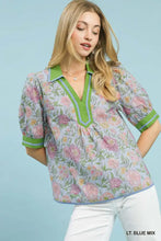 Light blue mix floral puff sleeve blouse with vibrant green collar and sleeve cuffs by Umgee with contrast trim