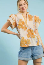 Umgee mix floral ruffle sleeve blouse in honey mix with orange and purple blossoms on a cream background