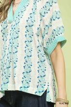 Umgee mix print boho blouse in off-white with blue floral pattern and teal zigzag trim on collar and cuffs
