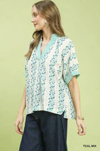 Umgee mix print boho short-sleeved blouse in teal and white with floral patterns and contrast trim on collar and cuffs