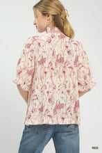 Umgee mixed print button front top featuring a blush pink floral blouse with ruffled short sleeves and soft red hues