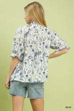 White blouse with blue floral pattern and ruffled sleeves featuring umgee mixed print button front design