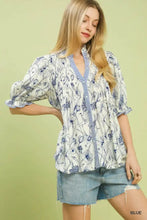 White umgee mixed print button front top with blue floral embroidery and striped v-neckline with puffed sleeves