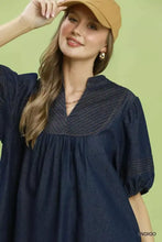 Indigo denim mini dress with v-neckline and subtle striped bodice detailing in the Umgee notched puff sleeve style