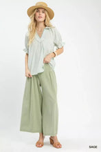 Light green wide-leg culottes paired with an umgee pinstripe v-neck ruffle sleeve blouse featuring soft flowing fabric