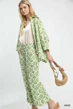 Light green and cream seashell-patterned umgee printed button down shirt with a relaxed kimono-style silhouette