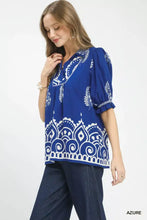 Blue blouse featuring white paisley and mandala patterns with puffed sleeves and ruffled hem split neck printed puff sleeve design