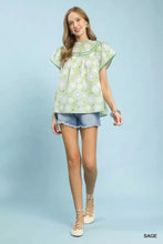 Light green Umgee retro floral smocked babydoll blouse with short flutter sleeves and gathered neckline