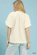 Cream-colored Umgee scalloped hem textured blouse with short puffed sleeves and a delicate scalloped hem detail