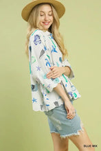 White umgee button-down blouse with playful blue and green starfish print seashells and coral sea-themed design