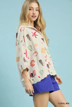 A women’s off-white Umgee button-down blouse with a vibrant coral mix starfish print in pink green yellow and black