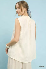 Cream-colored sleeveless textured notch neck top with vertical pleats by umgee ideal for casual wear