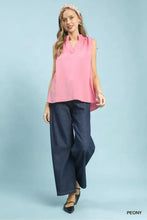 Pink umgee sleeveless textured notch neck blouse with soft flowing fabric and delicate ruffled neckline
