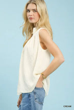 Cream-colored umgee sleeveless textured gauze top with a relaxed flowing silhouette and split neck detail