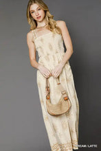 Beige tan woven crescent crossbody bag with Umgee smocked bodice jumpsuit