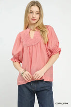 Coral pink umgee smocked yoke blouse featuring ruffled sleeves and a smocked neckline for stylish comfort