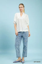 Off-white Umgee blouse with smocked yoke and ruffle sleeves featuring delicate lace trim