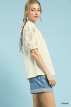 Cream-colored umgee blouse features delicate lace puff sleeves with textured fabric for elegant styling