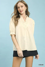 Cream-colored lightweight umgee textured check ruffle blouse with v-neck puff sleeves and ruffled neckline