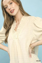 Cream-colored lightweight Umgee textured check ruffle v-neck blouse with subtle checkered pattern and ruffled neckline