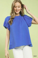 A vibrant royal blue umgee textured gauze ruffle neck blouse with lightweight fabric and puffed short sleeves
