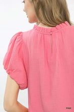 A vibrant pink umgee textured gauze ruffle neck boho top with puffed short sleeves and a ruffled neckline