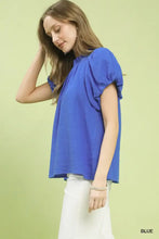 A vibrant royal blue umgee textured gauze ruffle neck boho top with puffed short sleeves and slightly crinkled fabric
