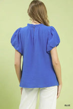 A vibrant royal blue umgee textured gauze ruffle neck blouse with lightweight fabric and puffed short sleeves