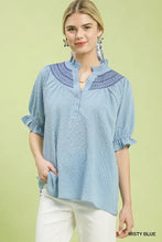 Misty blue umgee textured henley blouse featuring embroidered collar and ruffle cuffs on textured fabric