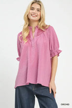 A soft pink umgee textured henley blouse featuring ruffle cuffs and a decorative embroidered collar