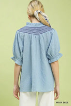 Misty blue umgee textured henley blouse with intricate embroidered neckline and ruffle cuffs on puffed sleeves