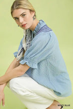 Misty blue umgee textured henley blouse with embroidered neckline and ruffle cuffs on lightweight fabric