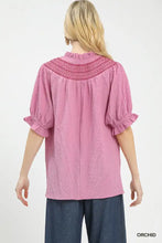 Pink orchid-colored umgee textured henley blouse with textured fabric and ruffled sleeves for stylish wear