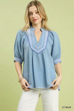 Light blue textured jacquard blouse with v-neck and puffed sleeves featuring jacquard contrast trim from umgee