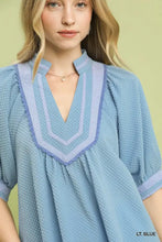 Light blue waffle-knit blouse featuring a v-neckline with striped scalloped jacquard contrast trim by umgee