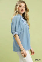 Light blue umgee textured jacquard blouse with striped jacquard contrast trim on collar and cuffs