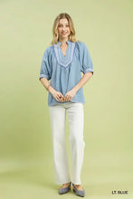 Light blue umgee textured jacquard blouse with v-neckline and puffed sleeves featuring jacquard contrast trim