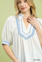 Off-white textured jacquard blouse with blue and white striped v-neck jacquard contrast trim by umgee