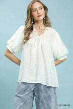 Off-white umgee blouse with textured lace trim v-neckline and puffed sleeves in boho style