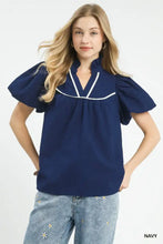 Navy blue umgee textured puff sleeve blouse with white piping and short puffed sleeves for a stylish look