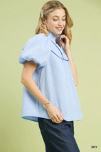 Light blue Umgee textured puff sleeve blouse features short puffed sleeves and a subtle ruffled high collar