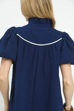 Navy blue Umgee textured puff sleeve blouse with short puffed sleeves and white curved trim along shoulder seam