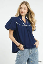 Navy blue umgee textured puff sleeve blouse with white piping along the neckline for a stylish look