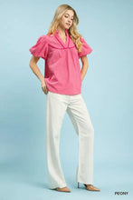 Pink umgee textured puff sleeve blouse with v-neckline and puffed short sleeves featuring textured puff sleeve details
