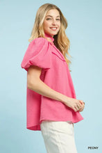 A vibrant pink umgee textured puff sleeve blouse with puffy short sleeves and a high neckline